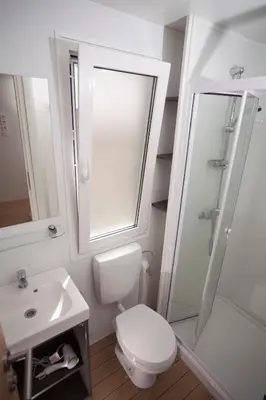 a bathroom with a toilet and a shower and a sink at Mediteran Travel Mobile Homes in Camping Terme Čatež in Brežice