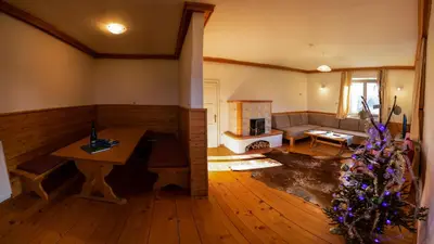 a living room with a table and a christmas tree at Magical Family Home 84 in Bohinj