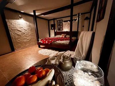 a table with a bowl of fruit in a room with a bed at Wellness Holiday House Lagev in Moravske Toplice