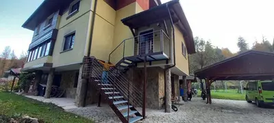 a building with a staircase on the side of it at Appartment Bezenica in Dobrova