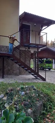 a man standing on top of a staircase at Appartment Bezenica in Dobrova