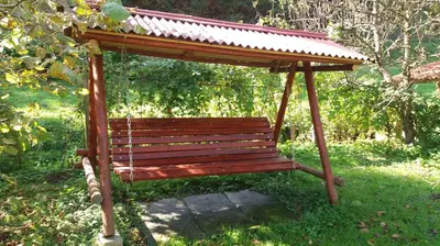a wooden bench with a roof on top of it at Appartment Bezenica in Dobrova