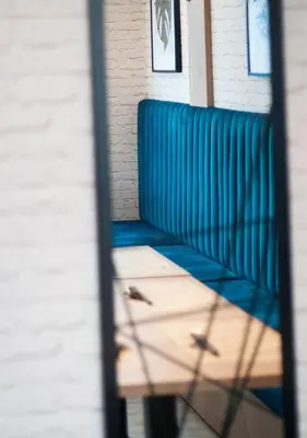 a blue bench sitting in front of a building at Urban Ring Hotel in Ljubljana