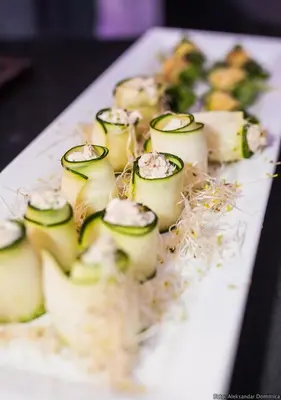 a white plate of food on a table at Urban Ring Hotel in Ljubljana