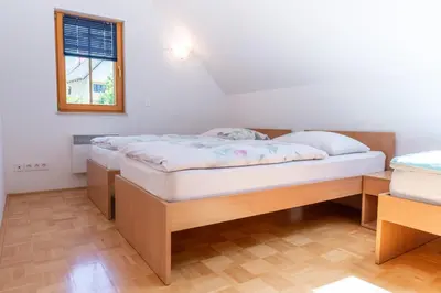 a bedroom with two beds and a window at House Parabola in Log pod Mangartom