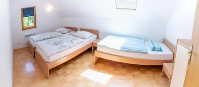 a room with two beds in a room at House Parabola in Log pod Mangartom