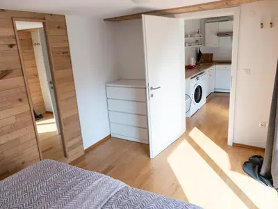 a bedroom with a bed and a kitchen at D&N Apartment in Ljubljana