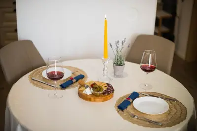 a table with two glasses of wine and a basket of food at ALEX BUMBLEBEE in Bled
