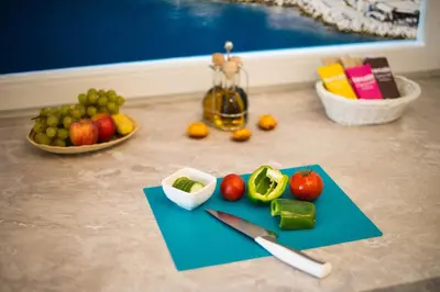 a cutting board with fruits and vegetables and a knife at ALEX BUMBLEBEE in Bled
