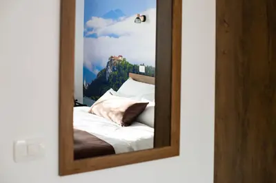 a reflection of a bed in a mirror at ALEX BUMBLEBEE in Bled
