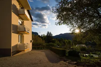 a view of a building with the sun in the distance at ALEX BUMBLEBEE in Bled
