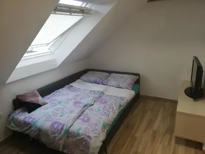a bed in a room with a window at Apartma Marička in Križe
