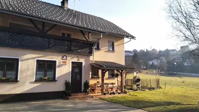 a house with a porch and a gazebo at Apartma Marička in Križe