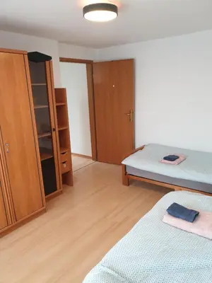 a room with a bed and a cupboard and a bedroom at Apartment Barje I in Ljubljana