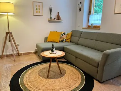a living room with a couch and a table at Chalet Harmony Rogla - apartment in Zreče