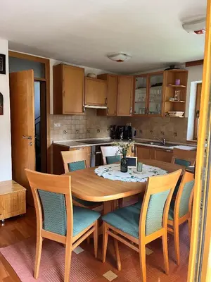 a kitchen with a wooden table and chairs at Chalet Harmony Rogla - apartment in Zreče