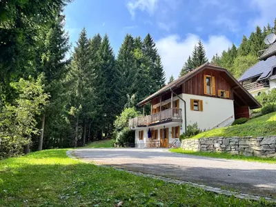 a house in the middle of a road at Chalet Harmony Rogla - apartment in Zreče