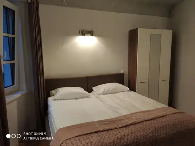 a bedroom with a bed with two pillows at Aparthotel Cross Street 4 in Ljubljana