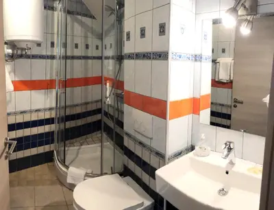 a bathroom with a toilet and a sink and a shower at Aparthotel Cross Street 4 in Ljubljana