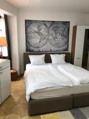 a bedroom with a large bed with a map on the wall at Aparthotel Cross Street 4 in Ljubljana