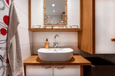 a bathroom with a white sink and a mirror at MichoArt in Ljubljana