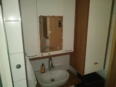 a small bathroom with a sink and a mirror at MichoArt in Ljubljana