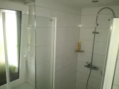 a bathroom with a shower with a glass door at MichoArt in Ljubljana
