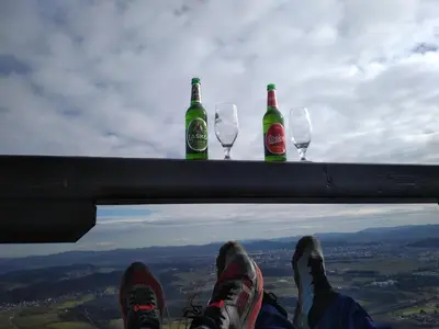 three bottles and two glasses on a ledge with their legs at MichoArt in Ljubljana