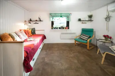 a room with a bed and a chair in it at Boho House 1 camp Terme Catez with promotional tickets prices in Čatež ob Savi