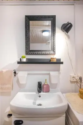 a bathroom with a white sink and a mirror at Boho House 1 camp Terme Catez with promotional tickets prices in Čatež ob Savi