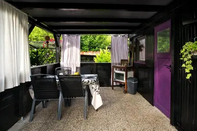 a dining room with a table and chairs and purple doors at Boho House 1 camp Terme Catez with promotional tickets prices in Čatež ob Savi