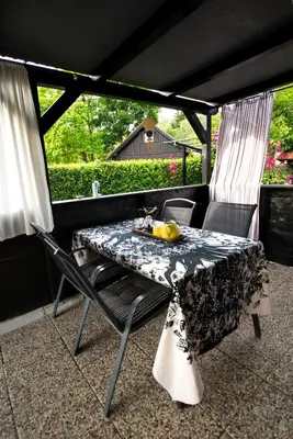 a table and chairs sitting on a patio at Boho House 1 camp Terme Catez with promotional tickets prices in Čatež ob Savi