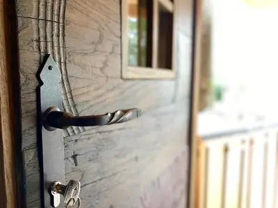 a wooden door with a door knob on it at Wooden lodge with jacuzzi in Rečica ob Savinji
