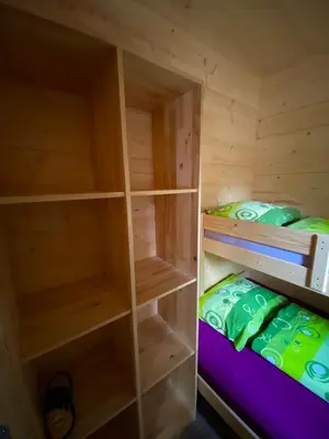 a wooden cabin with two bunk beds in it at Wooden lodge with jacuzzi in Rečica ob Savinji