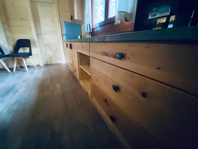 a large wooden chest of drawers in a room at Wooden lodge with jacuzzi in Rečica ob Savinji