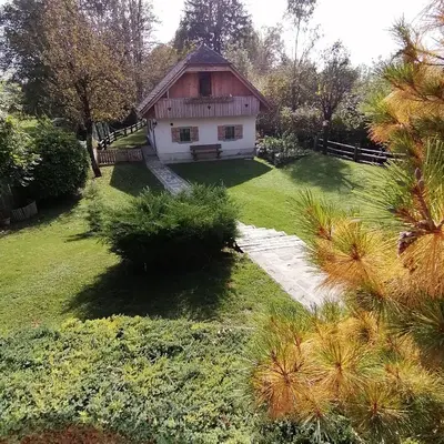a house in a garden with a path leading to it at Vila Jana in Radovljica