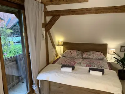 a bedroom with a bed with two pillows and a window at Vila Jana in Radovljica