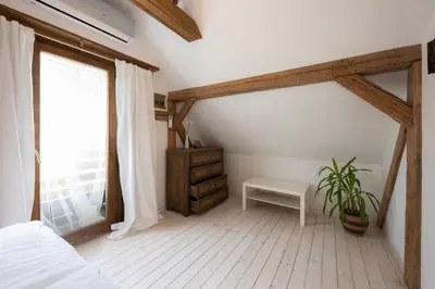 a bedroom with a bed and a table and a window at Vila Jana in Radovljica