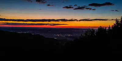 a view of a sunset from the top of a mountain at Panoramic View Cottage Heated Pool, Swimspa & Sauna in Pohorje