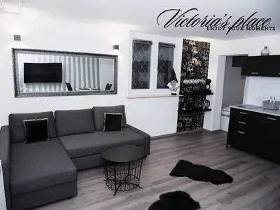 a living room with a couch and a table at Victoria's Place Apartment in Ljubljana