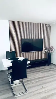 a living room with a tv and a table and chairs at Victoria's Place Apartment in Ljubljana