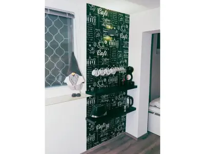 a room with a green wall with writing on it at Victoria's Place Apartment in Ljubljana