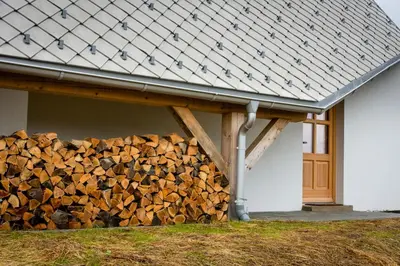 a pile of fire wood under a house at House On The Hill (Hiška Na Griču) in Spodnja Idrija