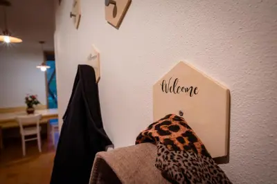 a sign on a wall with the word welcome at House On The Hill (Hiška Na Griču) in Spodnja Idrija