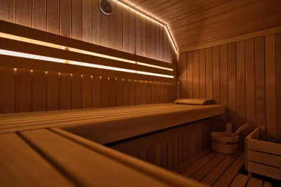 a sauna with a tub and lights in it at House On The Hill (Hiška Na Griču) in Spodnja Idrija
