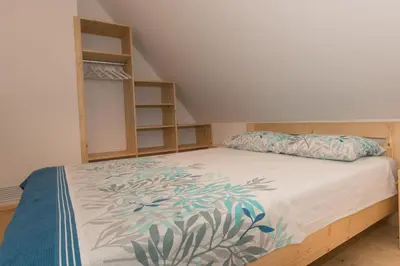 a bedroom with a bed and a book shelf at House On The Hill (Hiška Na Griču) in Spodnja Idrija