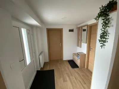 an empty room with a hallway with a door at Apartma Vidovič in Rateče