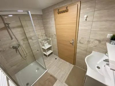 a bathroom with a shower with a glass door at Apartma Vidovič in Rateče