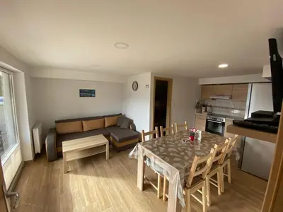 a living room with a table and a couch at Apartma Vidovič in Rateče