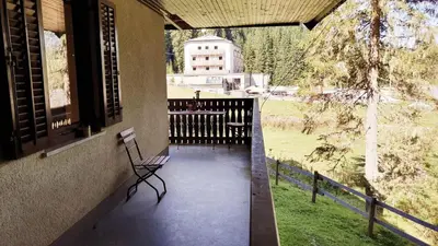 a porch with a bench and a view of a field at Apartment Ski Sara Pokljuka in Bled